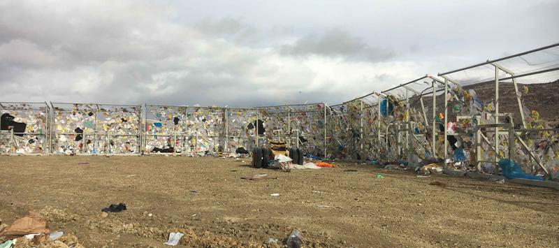 View of The BULL litter netting holding back litter at a landfill.